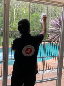 Professional Ndis cleaner wiping dinning mirror